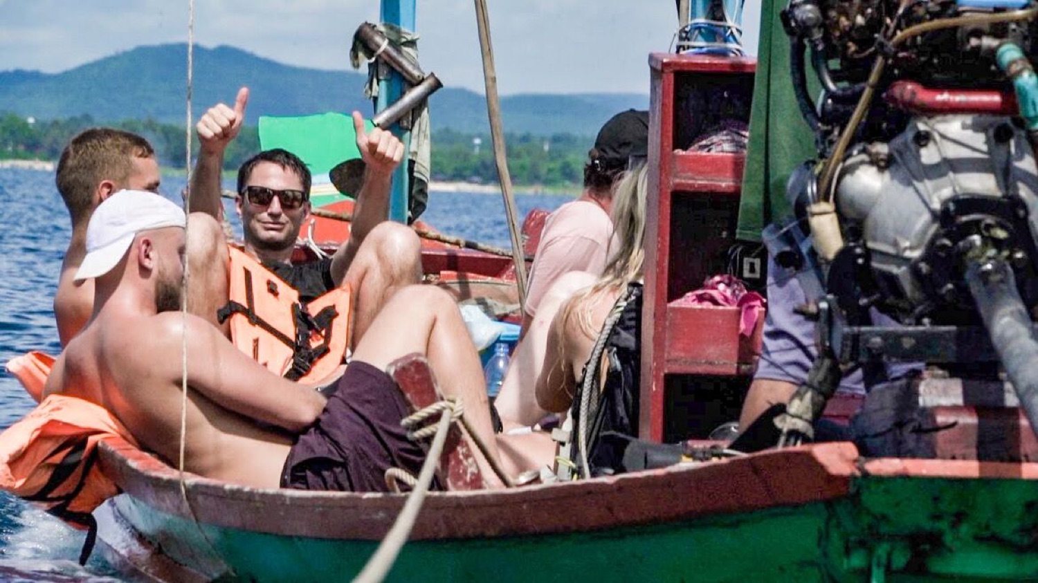 The group relaxing in the longtail boat on the crossing back to the mainland